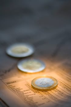 Three euro coins on the economic section