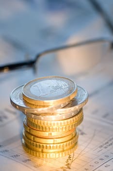 Stack of euro coins on a newspaper
