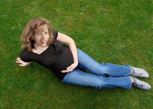 Pregnant woman on meadow
