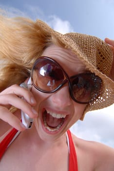 Woman talking on the phone on the beach