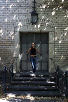 young woman in front of church portal