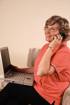 Woman talking on the phone with laptop