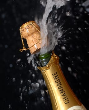 Splashing champagne bottle
