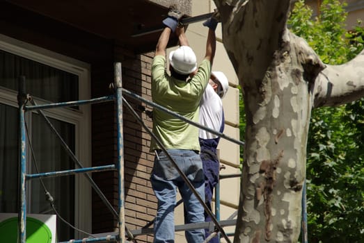 Construction workers - scaffolding - men
