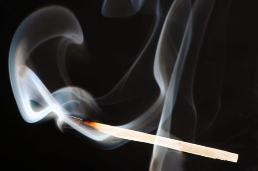 Match that has just gone out against a black background