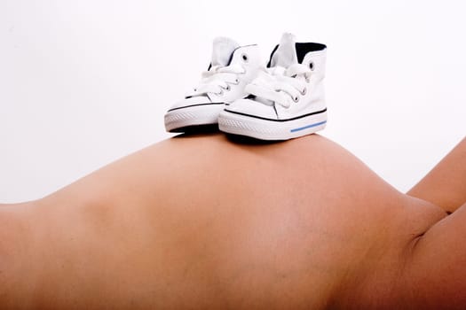 Baby shoes on mother's belly 2