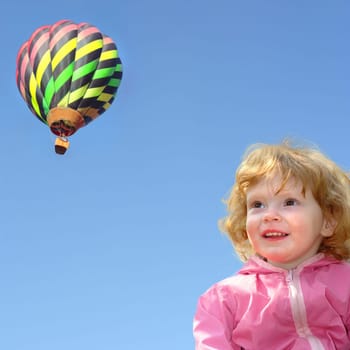 Little girl watching hot air balloon