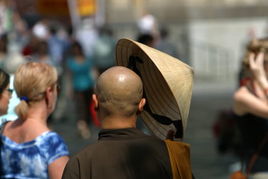 Asian monk with sun hat