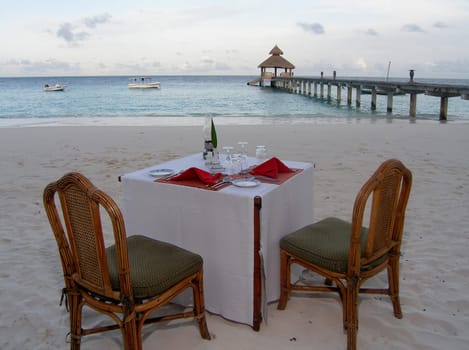 Table for candlelight dinner. When it is dark,another fire is lit.