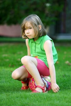 Child sitting on a ball
