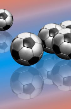 Soccer balls on a mirrored surface