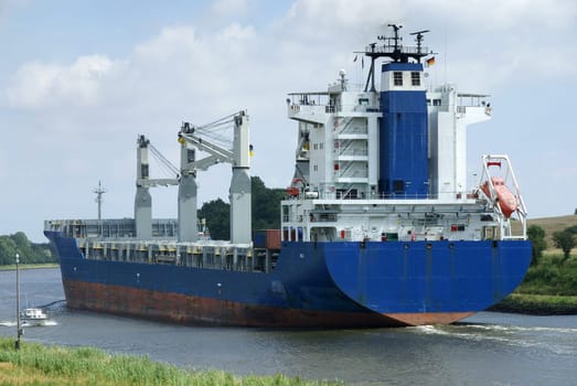 A 188m long colossus slowly pushes its way through the Kiel Canal