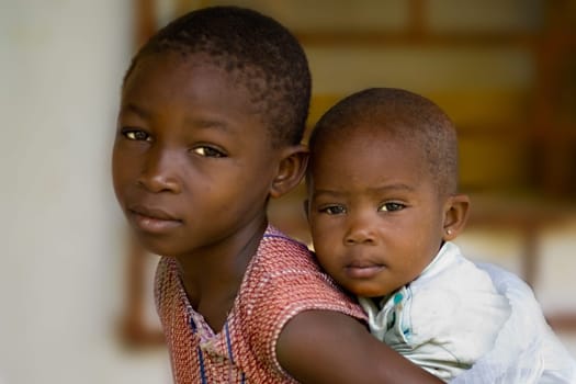 ... what is your future. The sister piggybacks on her brother,two children from an African village. The picture doesn't want to be early,it's rather sad.... Children of Africa,what is your future? Don't you also have the right to a future and a future?