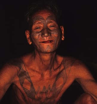 my "uncle"" Longshaw,member of the Konyakstames in the north of Nagaland (N/O-india). He still wears the traditional tattoo of the former headhunters. As a teenager,this T. was treated with bamboo sticks and a charcoal/fat mixture"