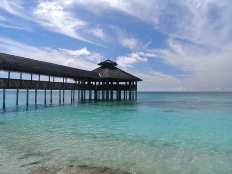 A restaurant above the waves of the Maldives.
