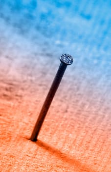 Nail in wooden board