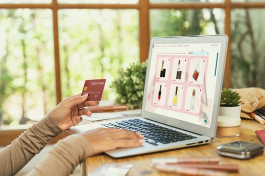 Woman shopping online on internet marketplace browsing for sale items for modern lifestyle and use credit card for online payment from wallet protected by crucial cyber security software