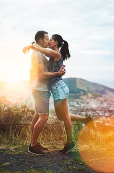 Kiss, hiking or couple hug in nature on outdoor date for love with support, loyalty or summer in park. Romantic man, wellness or woman on holiday vacation together to celebrate, relax or travel.