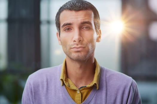 Portrait of businessman standing in office while working day