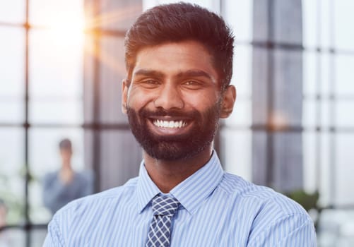 male investor beard looking at camera and smiling in modern office