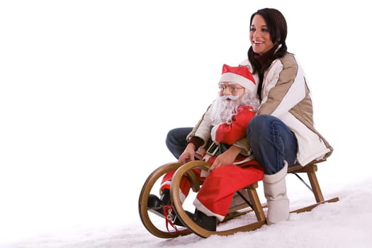 Woman riding sleigh with santa claus