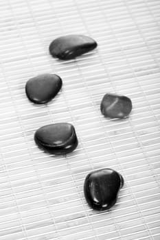 Zen stones on bamboo mat,black