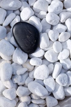 Black stone on ornamental pebbles