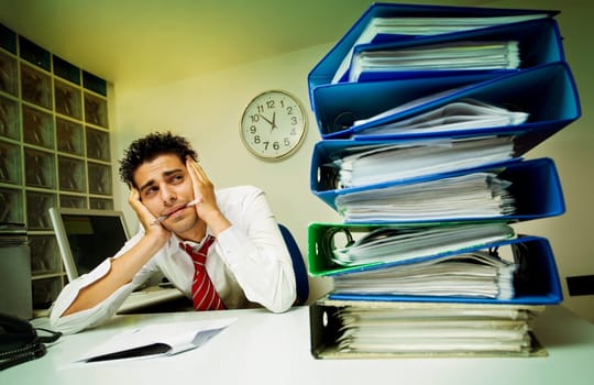 Exhausted businessman surrounded by