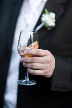 Groom holding glass