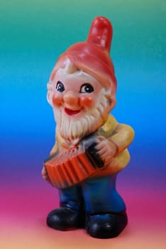 Garden gnome in front of color gradient