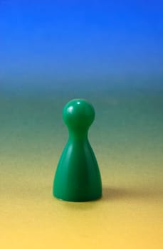 Green pawn in front of color gradient