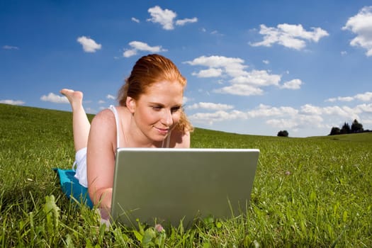 In the grass on the laptop