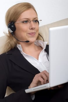 Young woman with headset and laptop