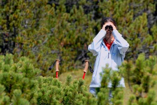 Hikerin observing chamois in the Swiss Büdnerland