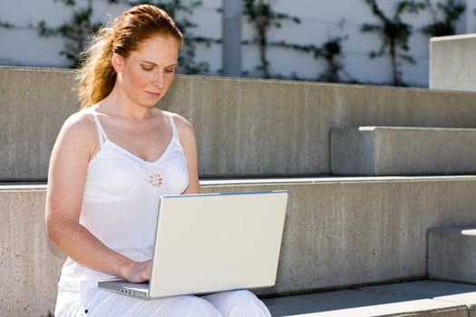 Female student with notebook on stairs