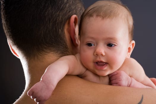 Baby on father's shoulder