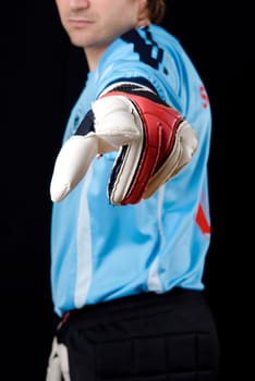 Goalkeeper points with glove on...