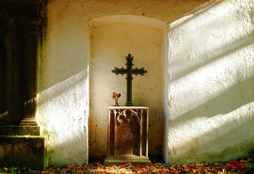 A very old grave site in Freiburg at the old cemetery with the effects of sun rays.