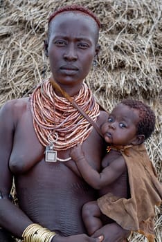 Plaid woman with baby,southern Ethiopia