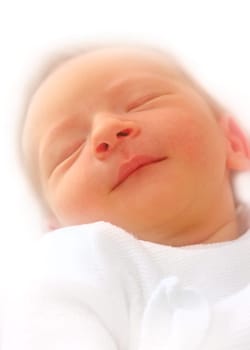 Newborn baby smiling in sleep