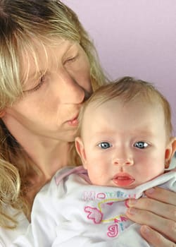 Young mother kissing her baby
