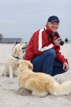 Man with dogs on the beach