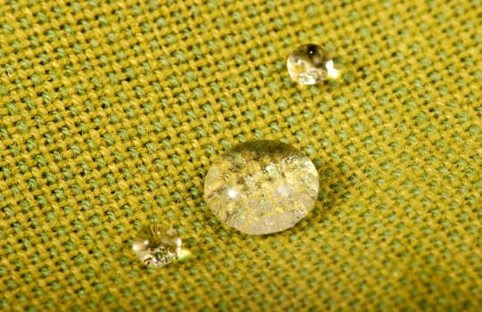 Water drops on green fabric