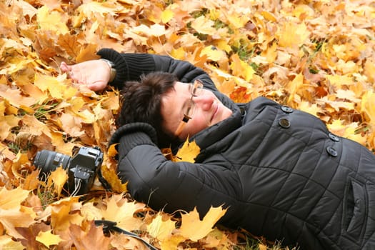 Woman lying in the leaves