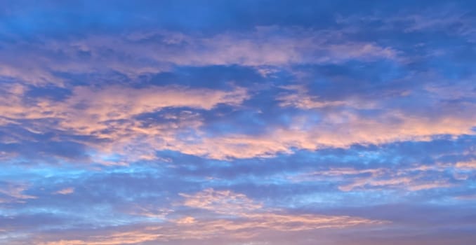 blue sunset sky with pink clouds for natural sky background.