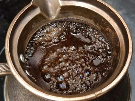 boiling coffee in a cezve close up