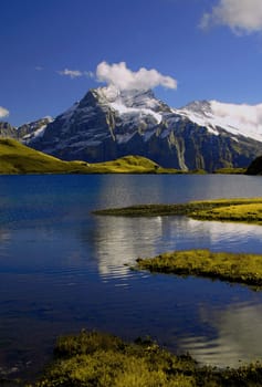 The Bachalpsee is a picturesque small mountain lake on the ridge above Grindelwald in the Bernese Oberland. It is located at 2,265 m above sea level and consists of two parts,separated by a small natural dam,with the lower part being 6 metres lower. By se