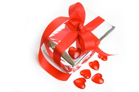 silver gift with red bow