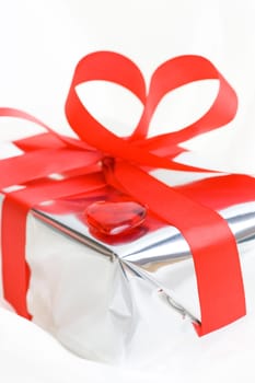 silver gift with red bow