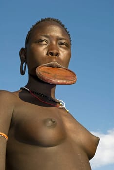 Young girl of the Mursi tribe with the typical clay lip plates,southern Ethiopia,near the Sudanese border.